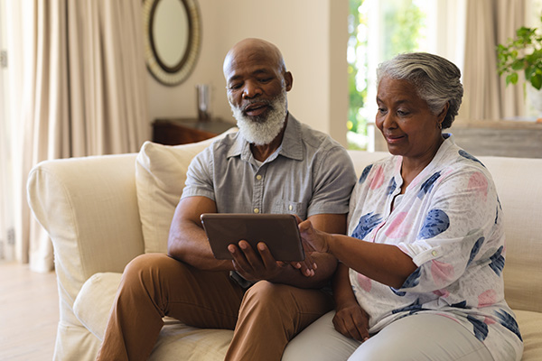 Senior african american couple sitting on sofa