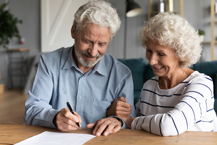 elderly couple signing a draft for a revocable living trust
